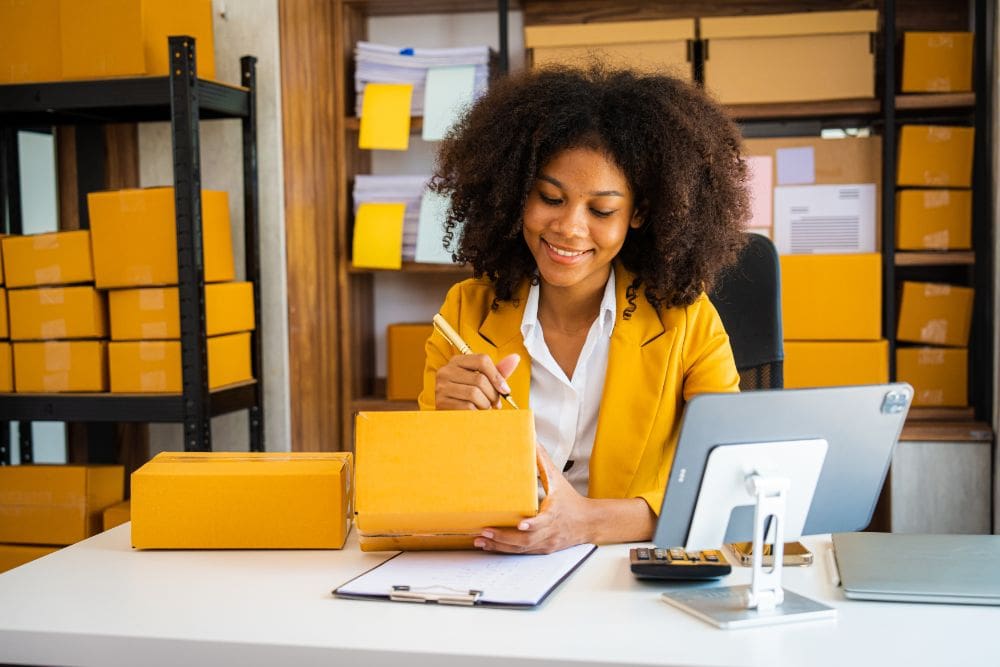 A company's products being sold by affiliate networks. A person working on a laptop, setting up a profitable business model