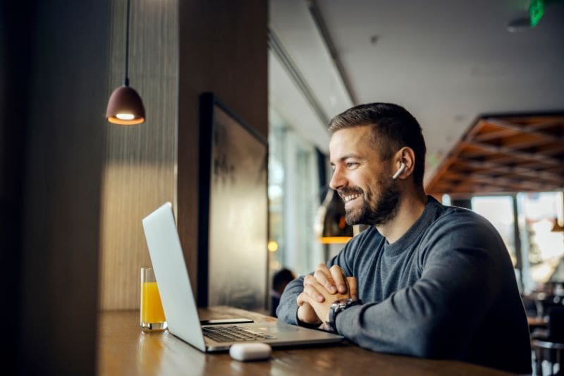 A person looking at a laptop screen, researching the right niche for their UK audience