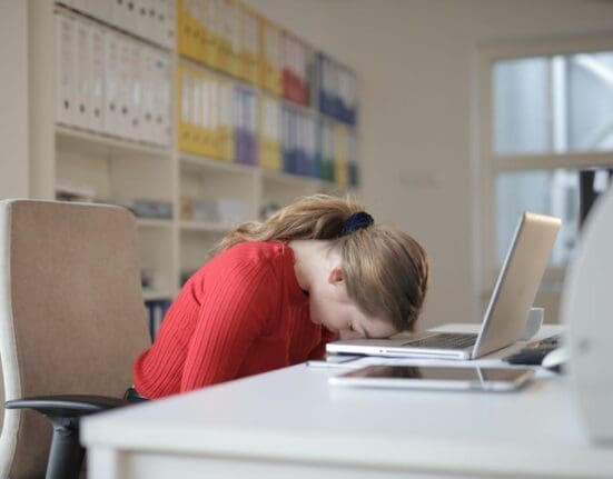 Freelance Social Media Marketing Consultant head on desk feeling stressed as her results