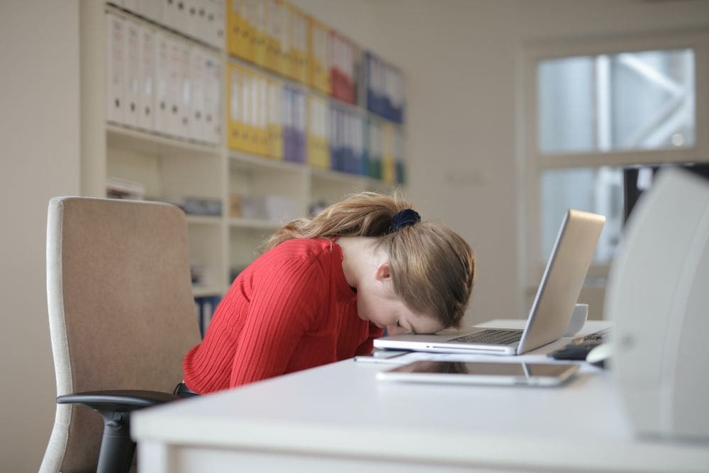 Freelance Social Media Marketing Consultant head on desk feeling stressed as her results