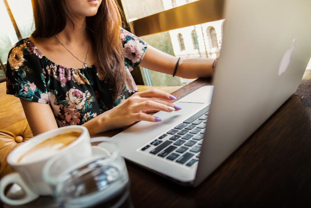 A person looking at a laptop with a graph showing the importance of content marketing and SEO synergy