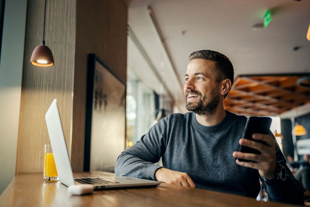 A person using a laptop to manage online reviews