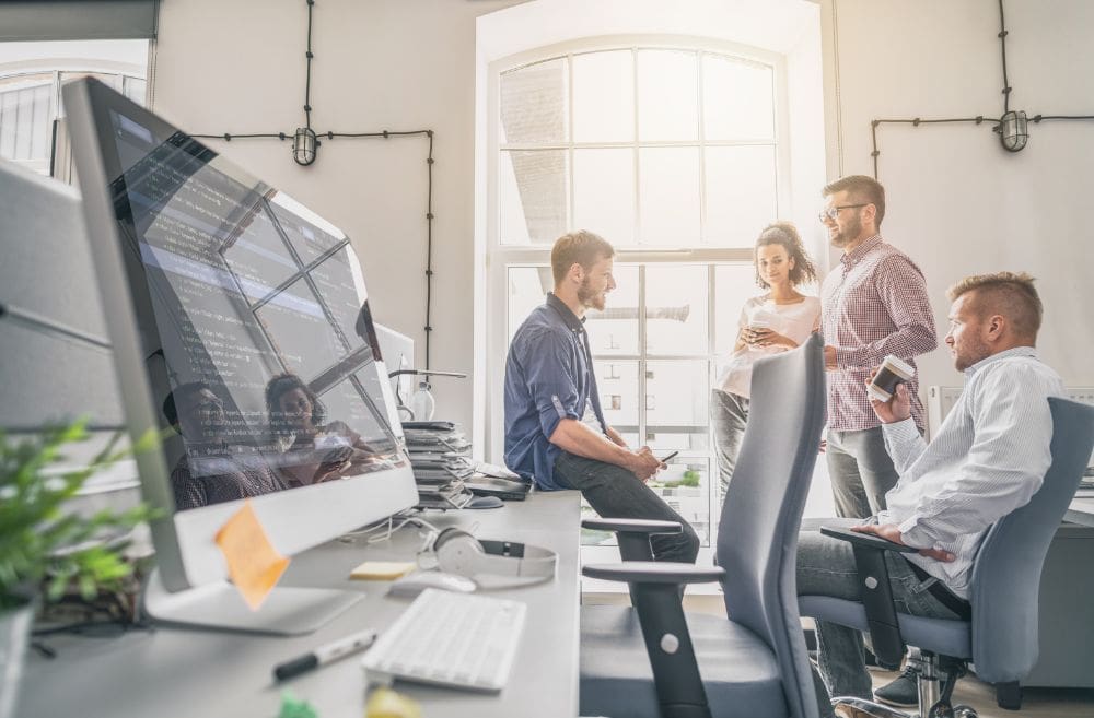 SEO consultants discussing the client SEO campaign in an office