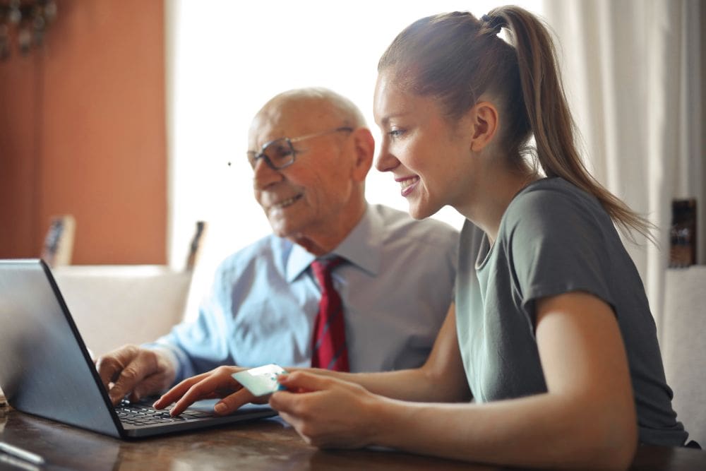 An image showing a person typing on a laptop with a notepad and pen, representing the first step in how to start affiliate marketing UK with a reliable web hosting service.