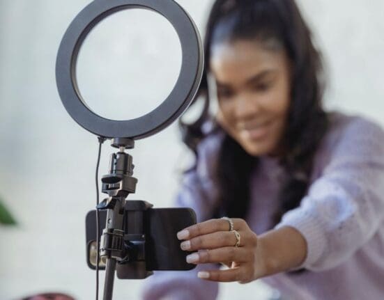 Influencer with light ring recording content