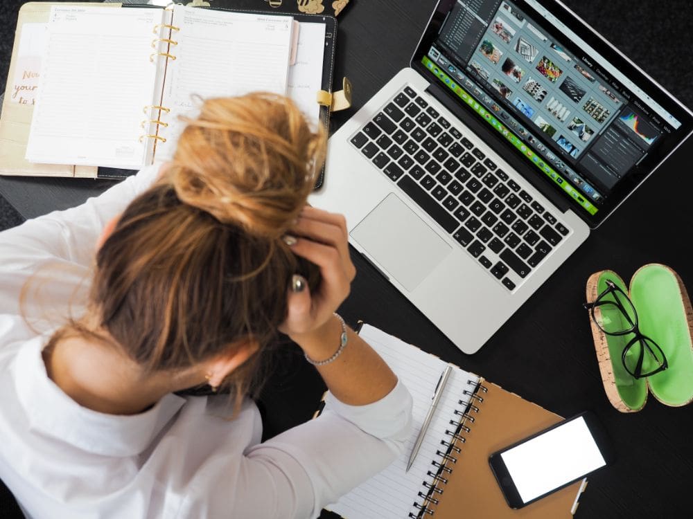 A person looking at a laptop with a graph showing the importance of on-page optimisation