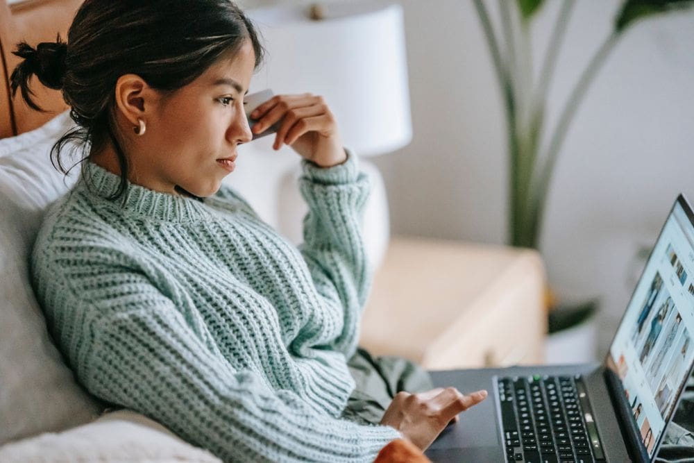 A person working on a laptop, setting up a dropshipping business